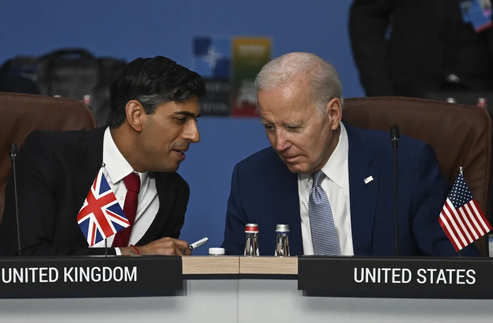 FILE - Britain's Prime Minister Rishi Sunak, left, and U.S. President Joe Biden speak at the start of the meeting of the North Atlantic Council (NAC) during the NATO Summit in Vilnius, Lithuania, July 11, 2023. U.S. and British militaries are bombing more than a dozen sites used by the Iranian-backed Houthis in Yemen, in a massive retaliatory strike using warship-launched Tomahawk missiles. (Paul Ellis/Pool Photo via AP, File)