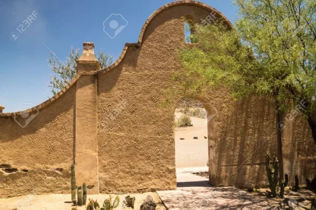 19913609-An-arched-wall-and-entry-to-Mission-San-Xavier-shows-the-distinctice-Spanish-colonia...webp