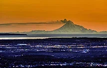 city-Anchorage-Alaska-sunset-Mount-Redoubt-erupting-AKSSPEH0003.webp