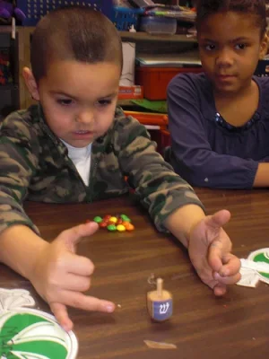 kids playing dreidel.webp
