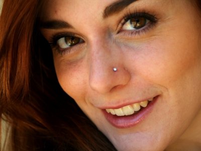 Smiling-Girl-Showing-Her-Right-Nose-Piercing-Picture.jpg