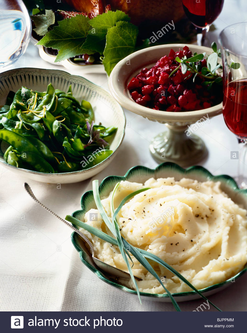 side-dishes-on-buffet-table-mashed-potatoes-snow-peas-cranberry-sauce-BJPPMM.jpg