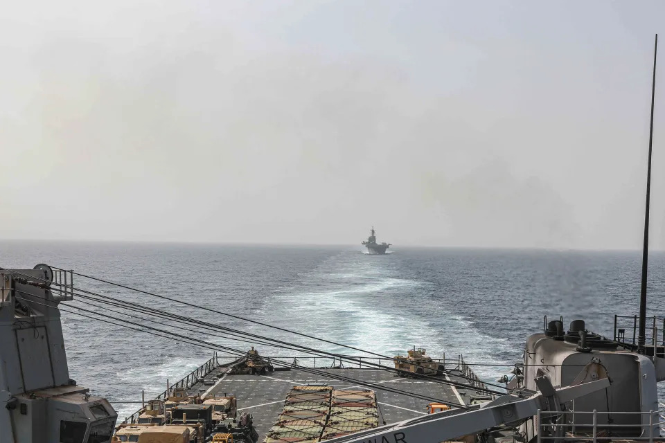 In this image provided by the U.S. Navy, the amphibious dock landing ship USS Carter Hall and amphibious assault ship USS Bataan transit the Bab al-Mandeb strait on Aug. 9, 2023. The top commander of U.S. naval forces in the Middle East says Yemen’s Houthi rebels are showing no signs of ending their “reckless” attacks on commercial ships in the Red Sea. But Vice Adm. Brad Cooper said in an Associated Press interview on Saturday that more nations are joining the international maritime mission to protect vessels in the vital waterway and trade traffic is beginning to pick up. (Mass Communications Spc. 2nd Class Moises Sandoval/U.S. Navy via AP)